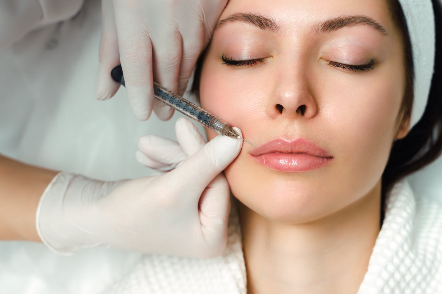 injection on lip of women going through dermal treatment
